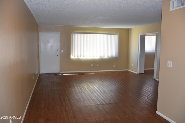 8124 N 33rd Dr, Phoenix, AZ 85051 - spare room featuring visible vents, plenty of natural light, and wood finished floors