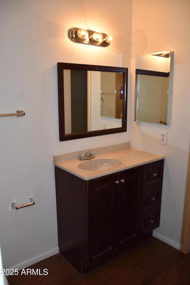 8124 N 33rd Dr, Phoenix, AZ 85051 - bathroom featuring baseboards, vanity, and wood finished floors