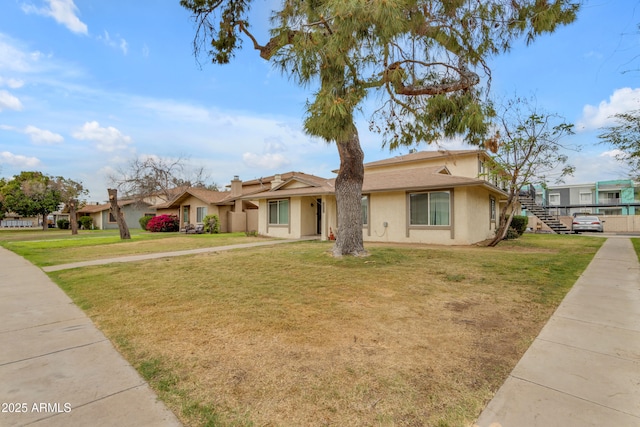 8124 N 33rd Dr, Phoenix, AZ 85051 - view of front of property featuring a front yard, stucco siding, and stairway