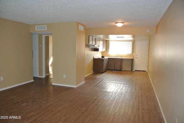 8124 N 33rd Dr, Phoenix, AZ 85051 - kitchen featuring baseboards, dark wood-style floors, light countertops, visible vents, and a sink