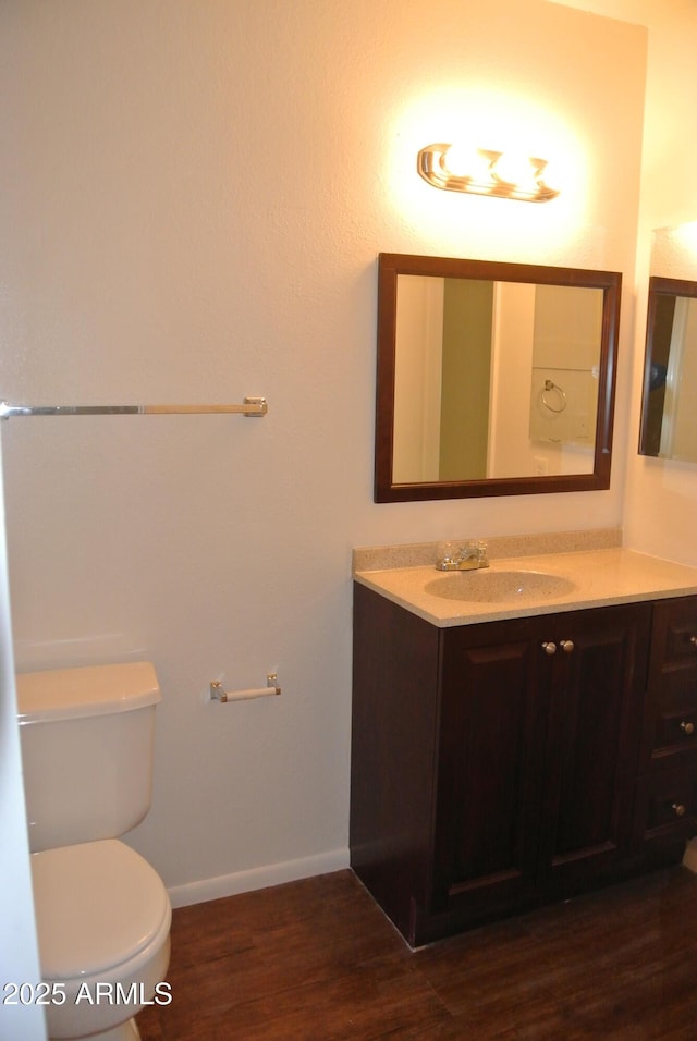 8124 N 33rd Dr, Phoenix, AZ 85051 - bathroom with toilet, wood finished floors, vanity, and baseboards