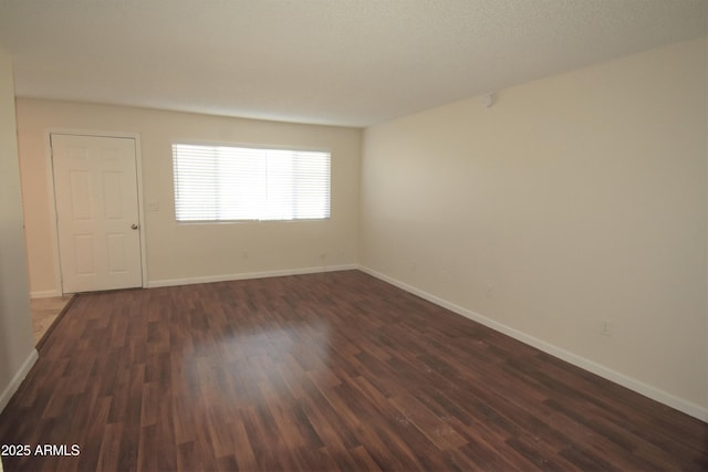 8124 N 33rd Dr, Phoenix, AZ 85051 - empty room featuring dark wood-style floors and baseboards