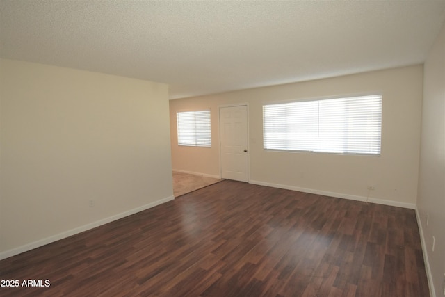 8124 N 33rd Dr, Phoenix, AZ 85051 - spare room with a textured ceiling, dark wood-style flooring, and baseboards