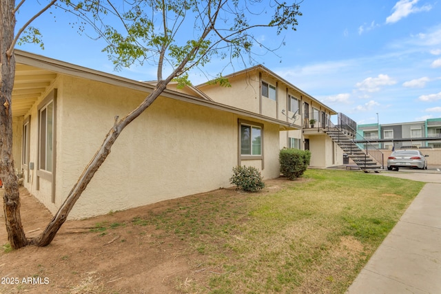 8124 N 33rd Dr, Phoenix, AZ 85051 - view of side of property featuring a yard, stucco siding, and stairs