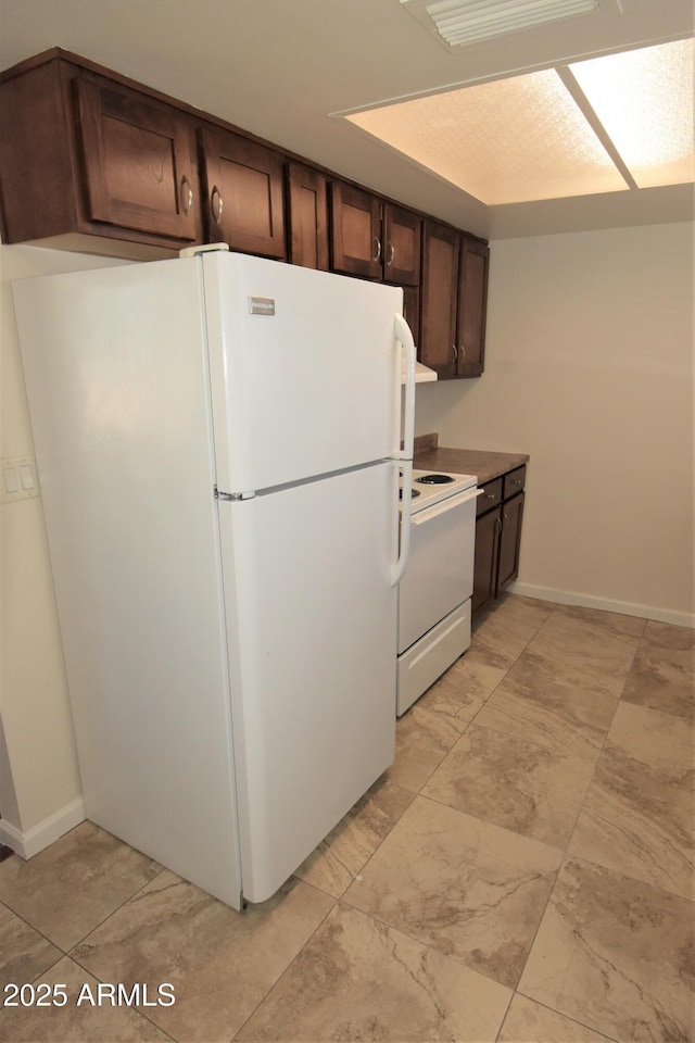 8124 N 33rd Dr, Phoenix, AZ 85051 - kitchen with baseboards, white appliances, and dark brown cabinetry
