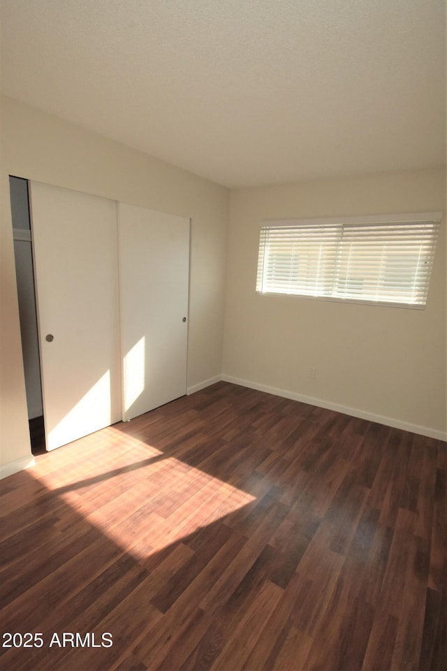 8124 N 33rd Dr, Phoenix, AZ 85051 - unfurnished room featuring dark wood-style flooring and baseboards