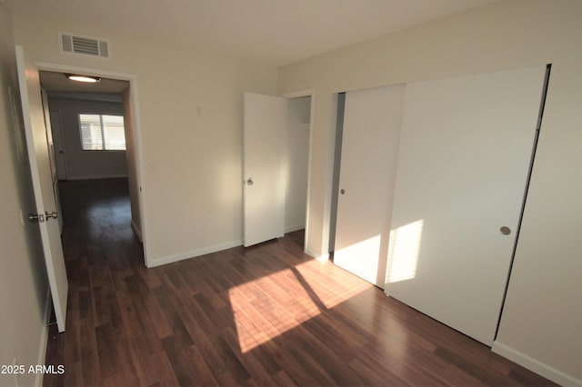 8124 N 33rd Dr, Phoenix, AZ 85051 - unfurnished bedroom featuring visible vents, a closet, baseboards, and dark wood finished floors