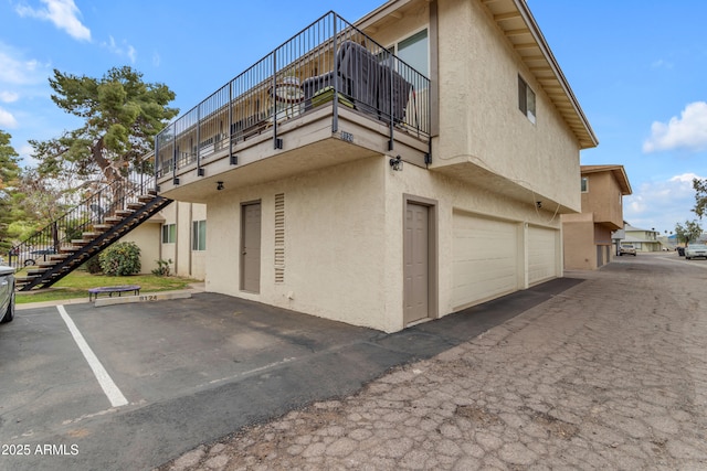 8124 N 33rd Dr, Phoenix, AZ 85051 - view of home's exterior featuring a garage, stairs, and stucco siding