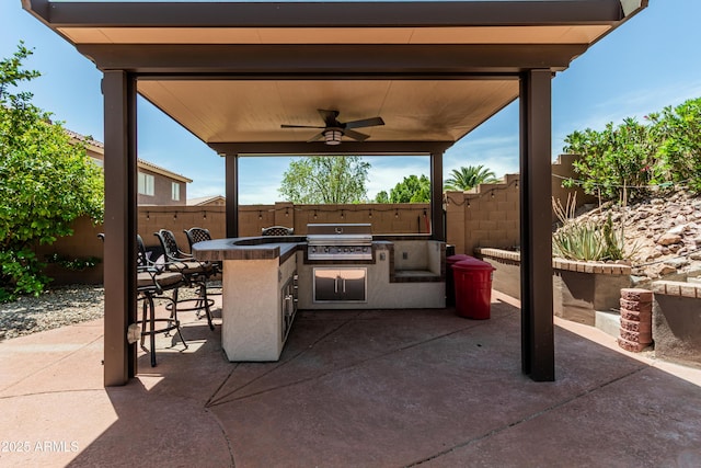6422 W Range Mule Dr, Phoenix, AZ 85083 - view of patio featuring exterior kitchen, area for grilling, a fenced backyard, ceiling fan, and an outdoor bar