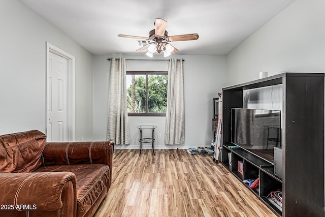 6422 W Range Mule Dr, Phoenix, AZ 85083 - living area with light wood-style flooring, a ceiling fan, and baseboards