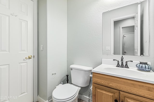 6422 W Range Mule Dr, Phoenix, AZ 85083 - half bath with vanity, toilet, a textured wall, and baseboards