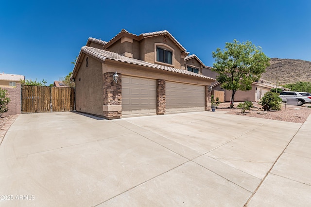 6422 W Range Mule Dr, Phoenix, AZ 85083 - view of front facade with stucco siding, driveway, a tile roof, fence, and a mountain view