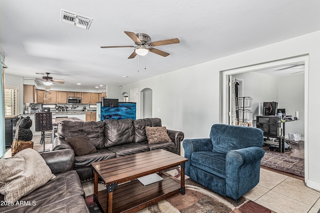 6422 W Range Mule Dr, Phoenix, AZ 85083 - living room with ceiling fan, arched walkways, light tile patterned floors, and recessed lighting