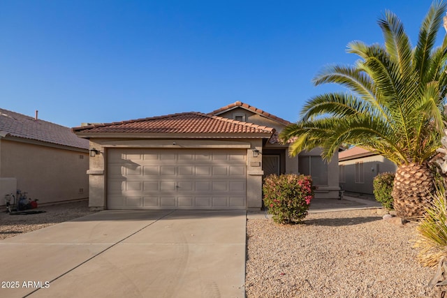 view of front of property featuring stucco siding, an attached garage, a tile roof, and driveway