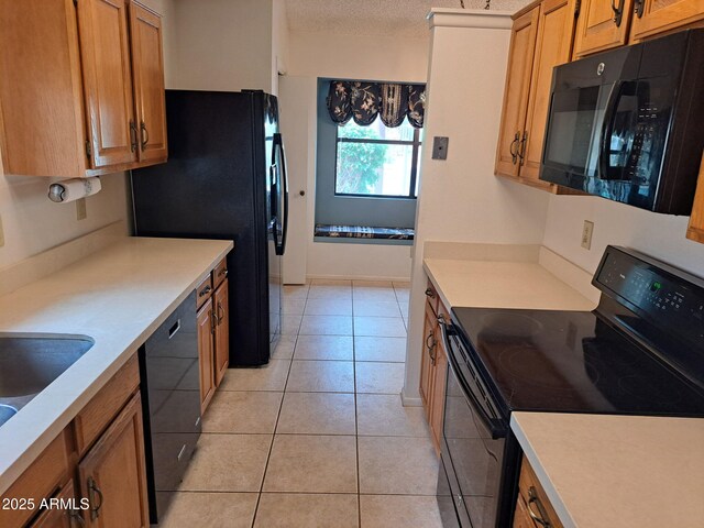 7420 W Morrow Dr, Glendale, AZ 85308 - kitchen with black appliances, light countertops, brown cabinets, light tile patterned flooring, and a textured ceiling