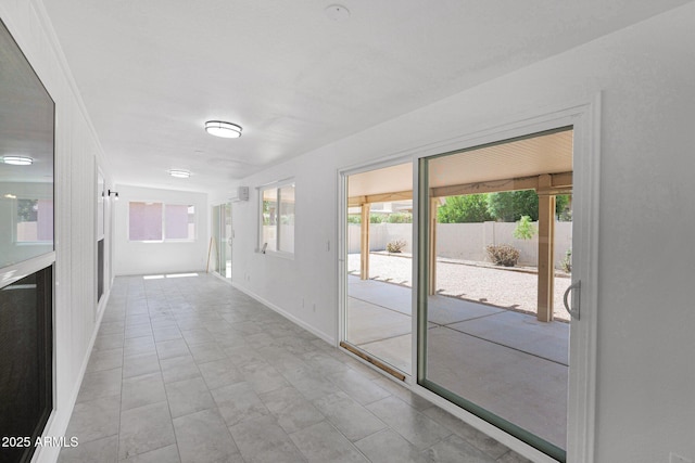 corridor featuring baseboards