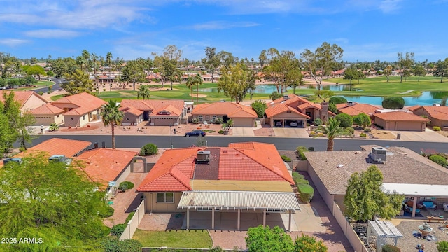 aerial view of residential area featuring a nearby body of water and a golf club