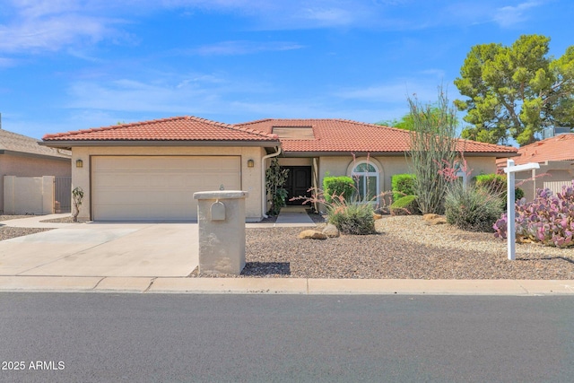 view of front facade with stucco siding, an attached garage, a tiled roof, and driveway
