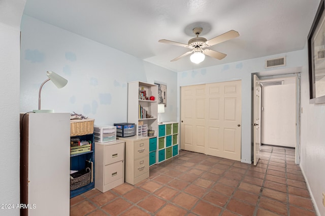 office space with dark tile patterned flooring and ceiling fan