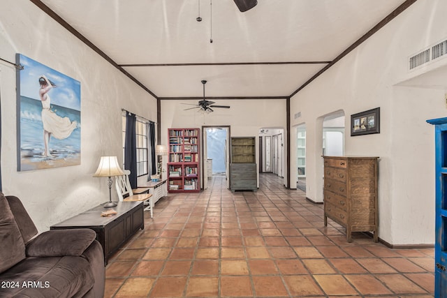 living room featuring a wealth of natural light, a towering ceiling, ceiling fan, and ornamental molding