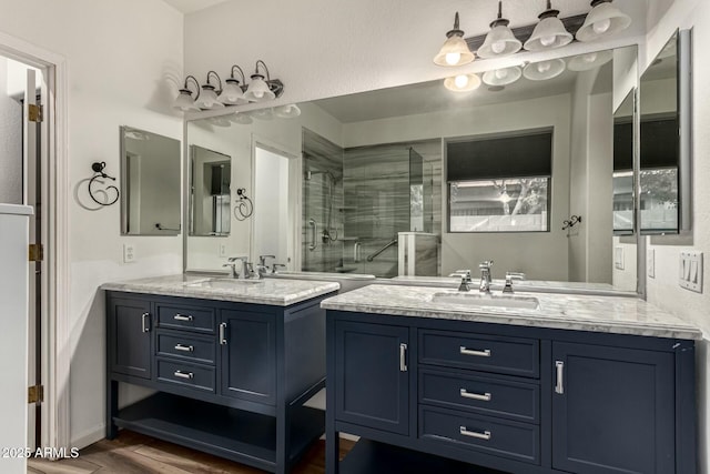 bathroom featuring hardwood / wood-style flooring, vanity, and a shower with door