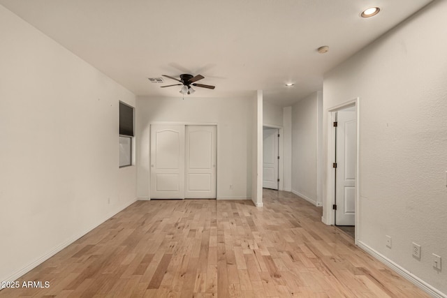 empty room featuring light hardwood / wood-style flooring and ceiling fan