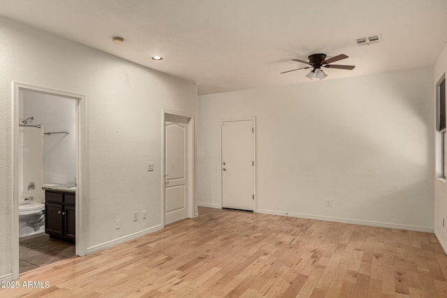 unfurnished bedroom with connected bathroom, ceiling fan, and light wood-type flooring