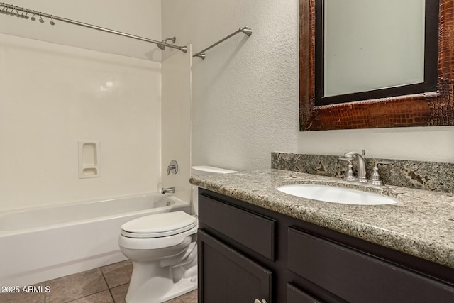 full bathroom featuring toilet, vanity, tile patterned flooring, and bathing tub / shower combination