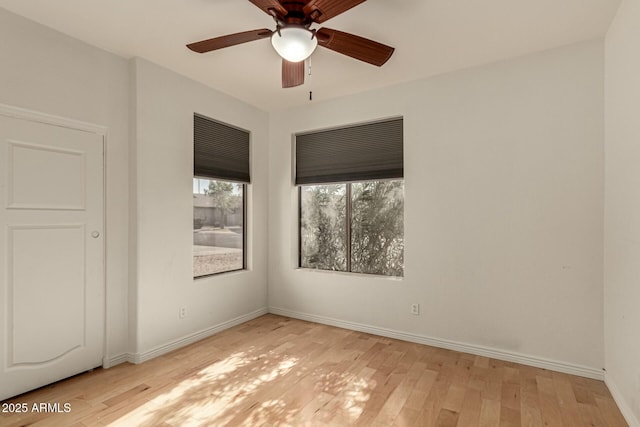 unfurnished room with ceiling fan and light wood-type flooring