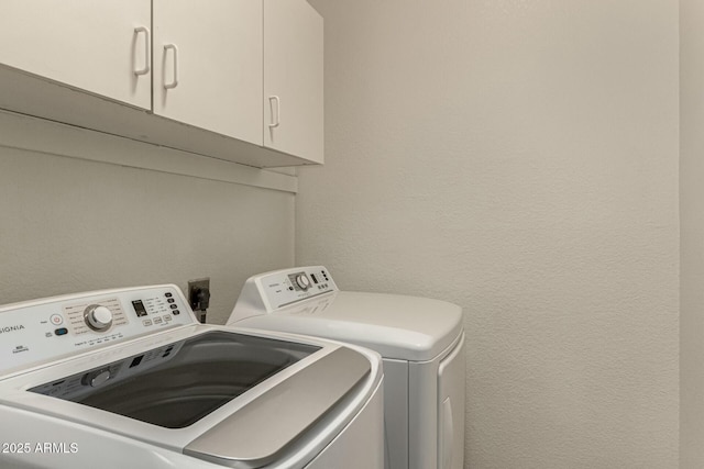 washroom with cabinets and independent washer and dryer