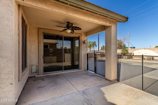 view of patio featuring ceiling fan and an empty pool