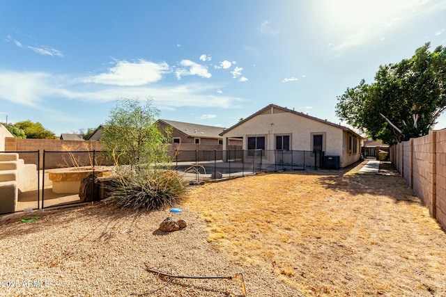 view of yard featuring central AC unit and a swimming pool