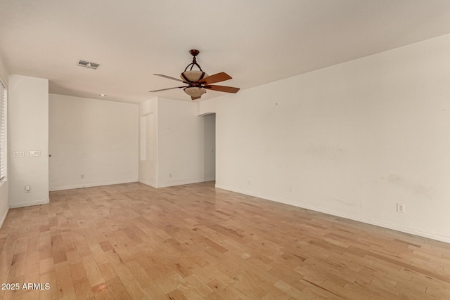 empty room with ceiling fan and light wood-type flooring