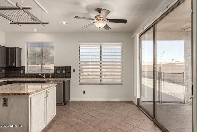 kitchen featuring decorative backsplash, ceiling fan, dishwasher, and light tile patterned floors