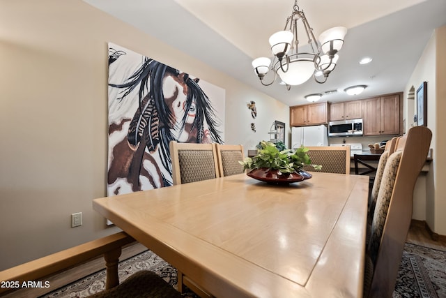 dining room with visible vents and a notable chandelier