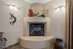 interior space featuring a glass covered fireplace and wood finished floors