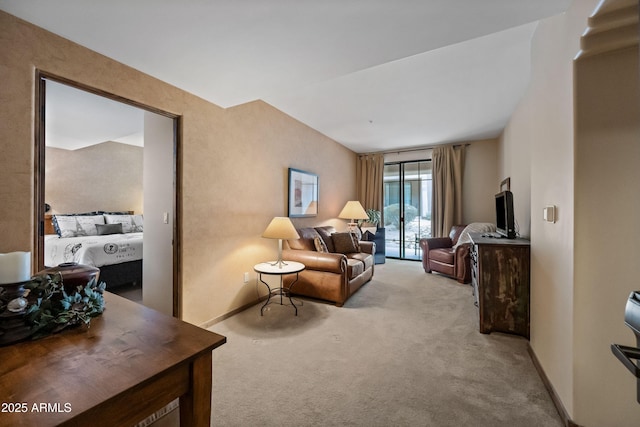 living area with baseboards and light colored carpet