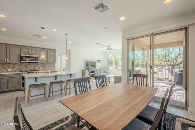 dining area with ceiling fan, light hardwood / wood-style floors, and a wealth of natural light