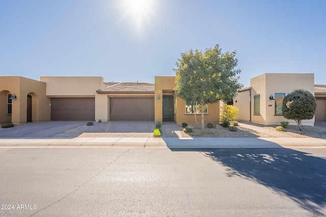 pueblo-style house with a garage