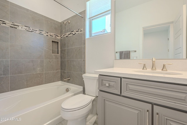 full bathroom with vanity, tiled shower / bath combo, and toilet