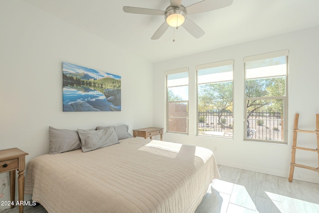 bedroom with ceiling fan and multiple windows