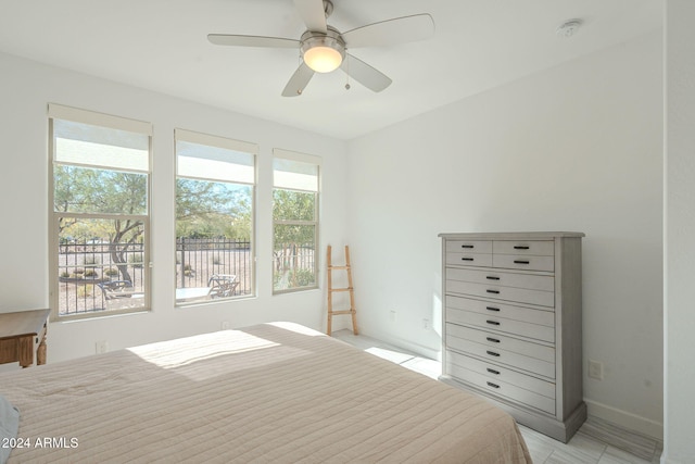 unfurnished bedroom featuring multiple windows and ceiling fan