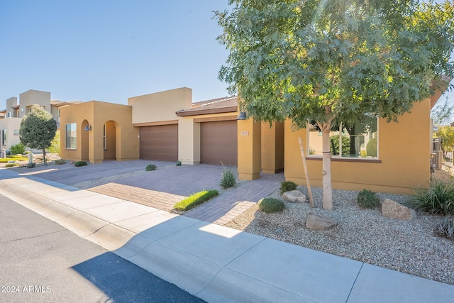 pueblo-style home with a garage