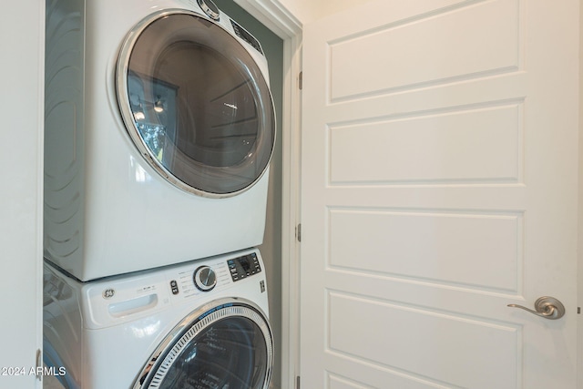 washroom featuring stacked washer / drying machine