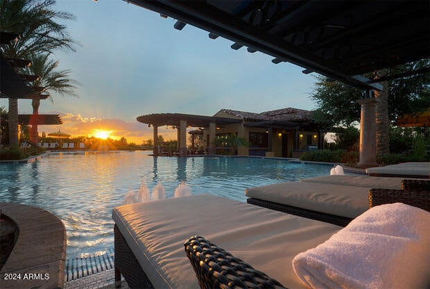 pool at dusk with a water view