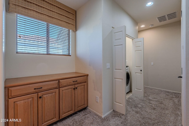 washroom featuring light carpet and washer / dryer