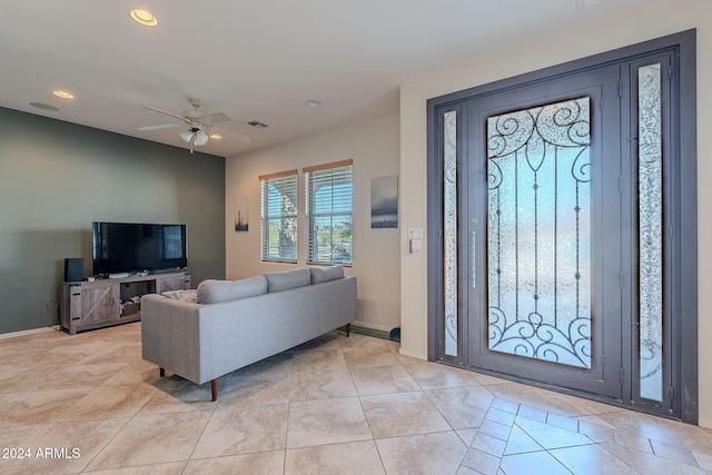 tiled entryway featuring ceiling fan