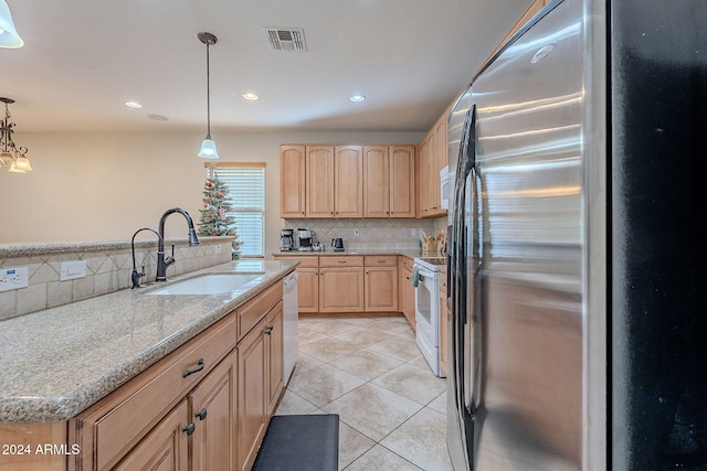 kitchen with a center island, white appliances, sink, decorative backsplash, and decorative light fixtures