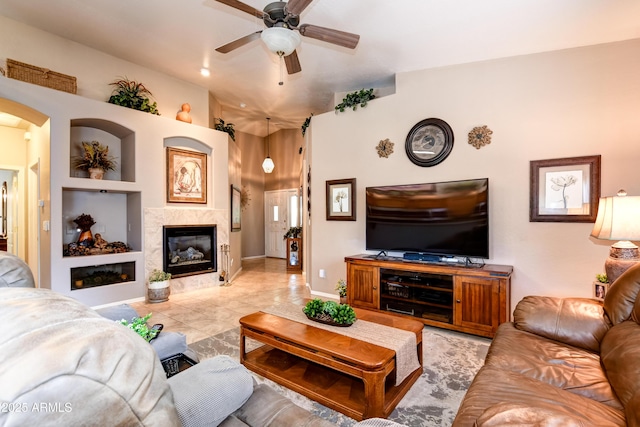 5461 N Bremont Way, Prescott Valley, AZ 86314 - living area with ceiling fan, a tile fireplace, and arched walkways