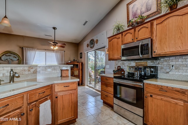 5461 N Bremont Way, Prescott Valley, AZ 86314 - kitchen featuring stainless steel appliances, lofted ceiling, backsplash, brown cabinets, and light countertops